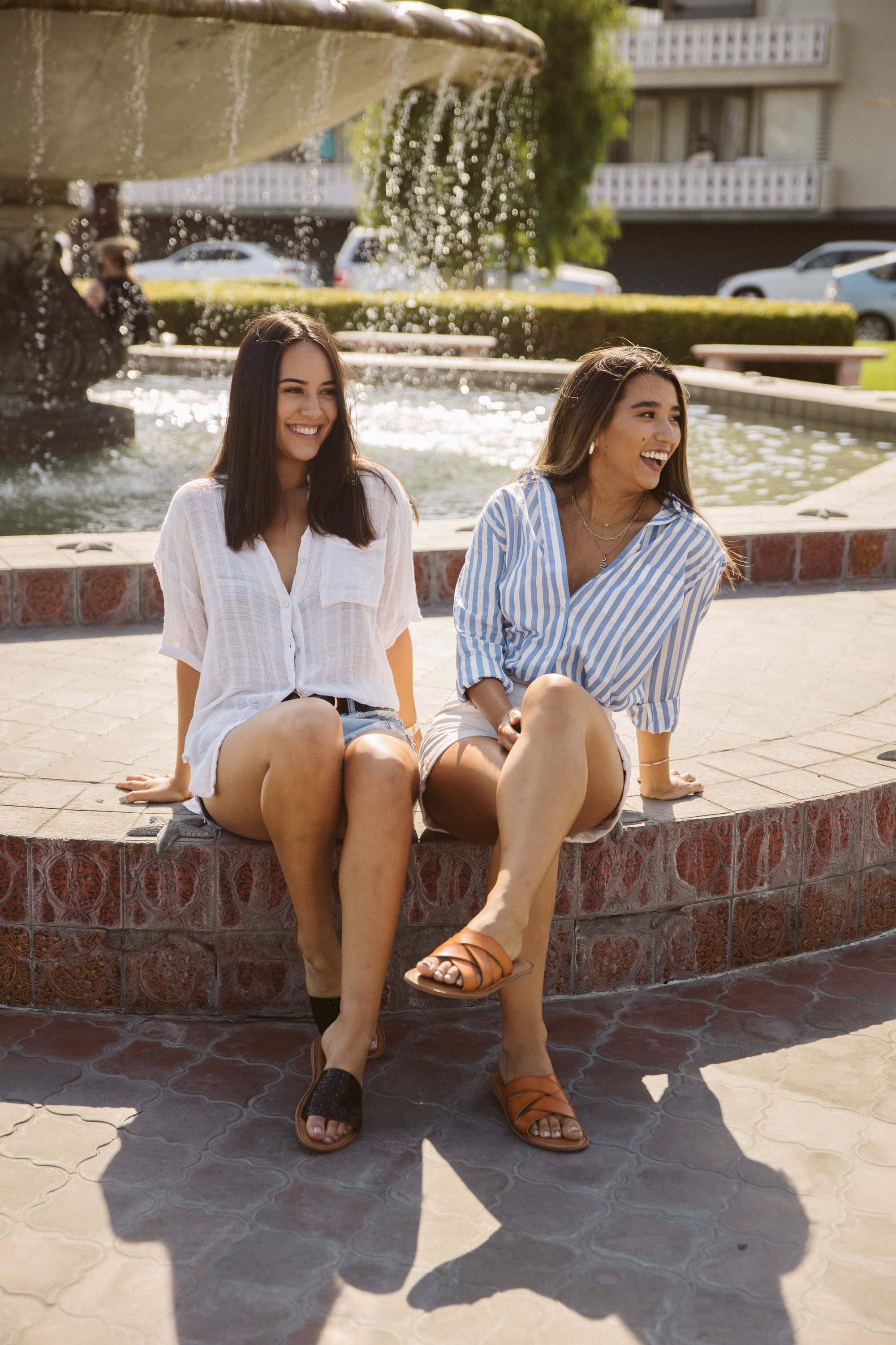 A pair of Women's Sandals Biarritz in black with a trendy perforated design and cushioned sole, perfect for summer outfits.