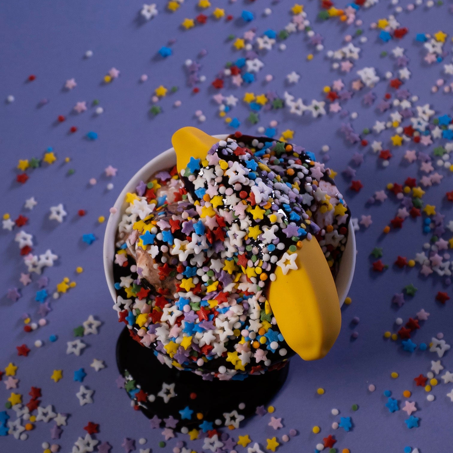 A vibrant yellow Banana Emojibator toy, shaped like a banana, showcasing its sleek design and waterproof features.