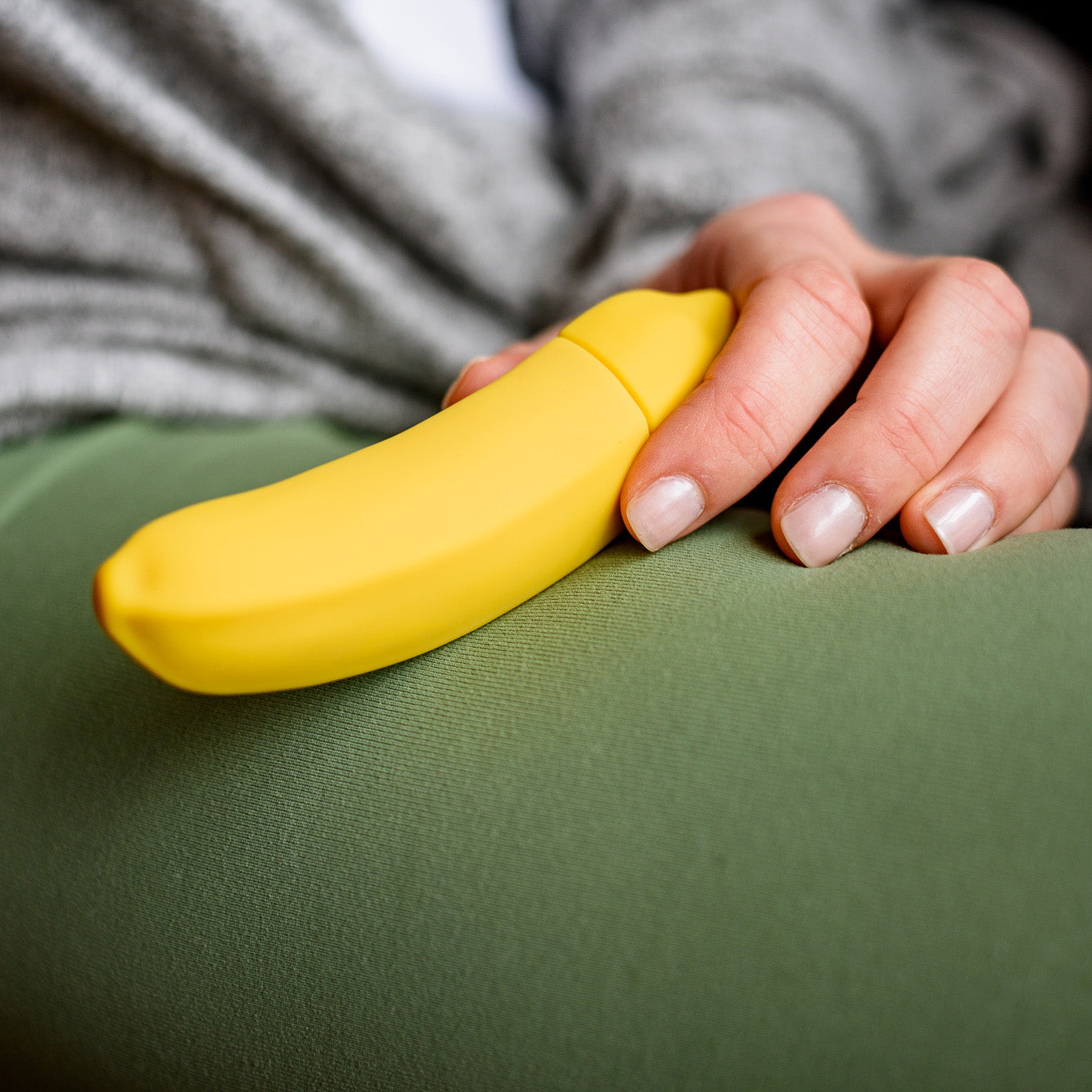 A vibrant yellow Banana Emojibator toy, shaped like a banana, showcasing its sleek design and waterproof features.