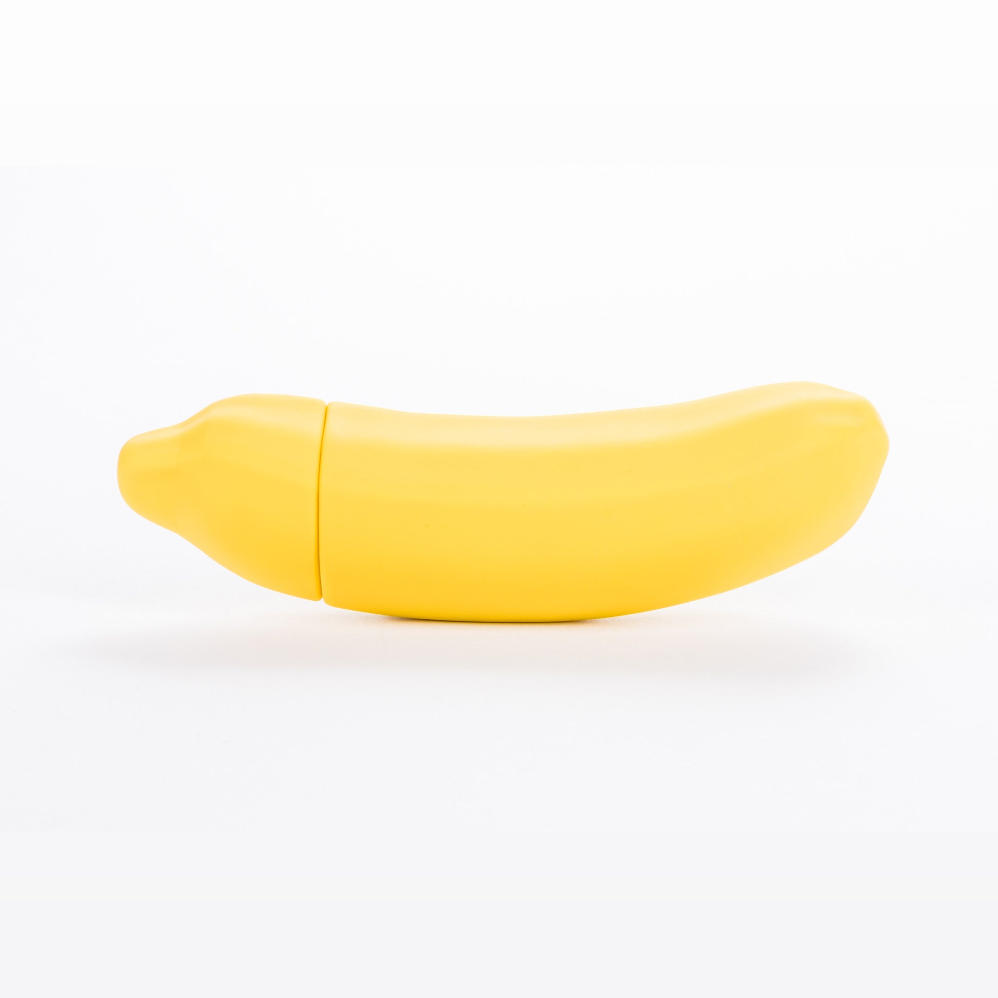 A vibrant yellow Banana Emojibator toy, shaped like a banana, showcasing its sleek design and waterproof features.