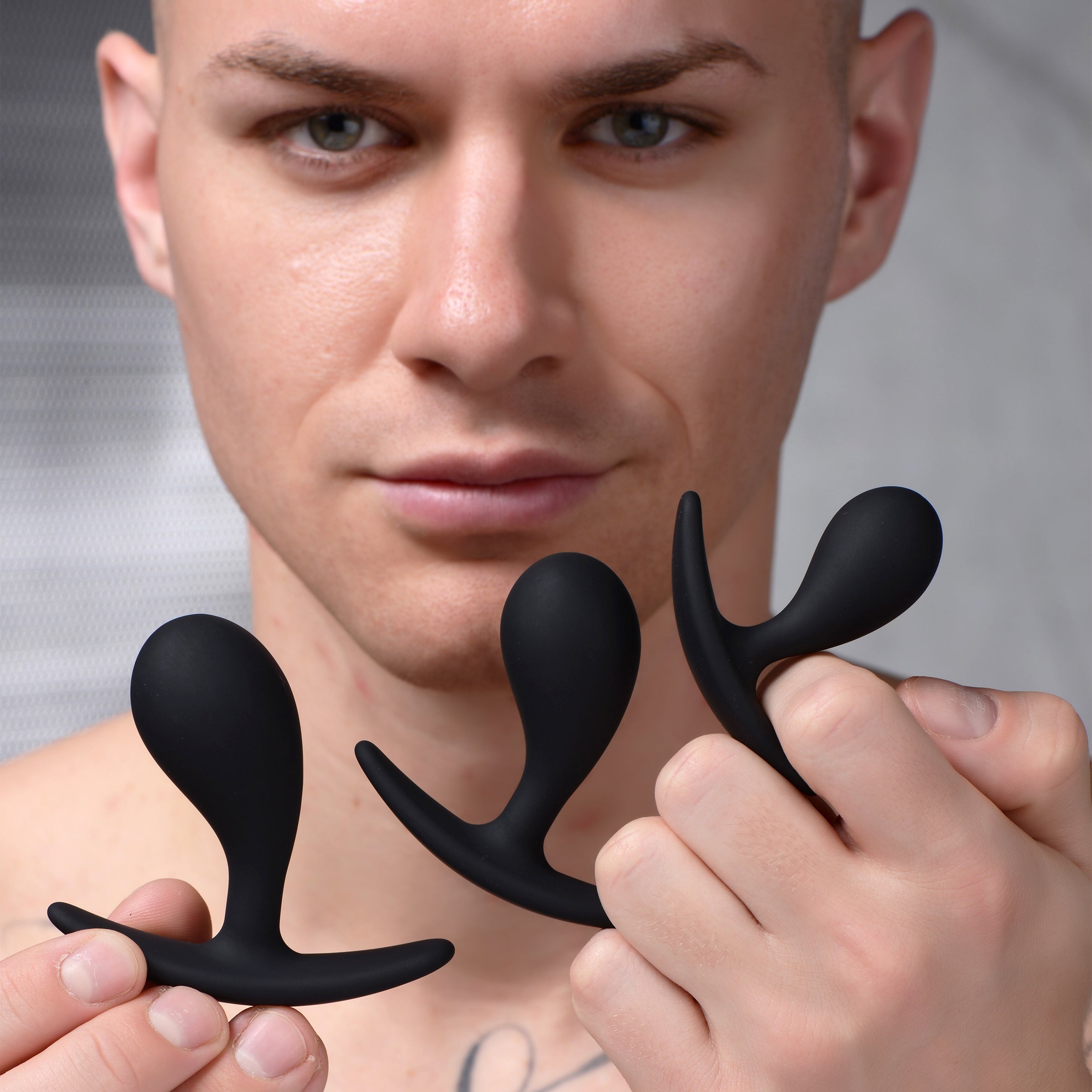 Dark Droplets 3 Piece Curved Silicone Anal Trainer Set in black, showcasing three graduated sizes for anal pleasure.