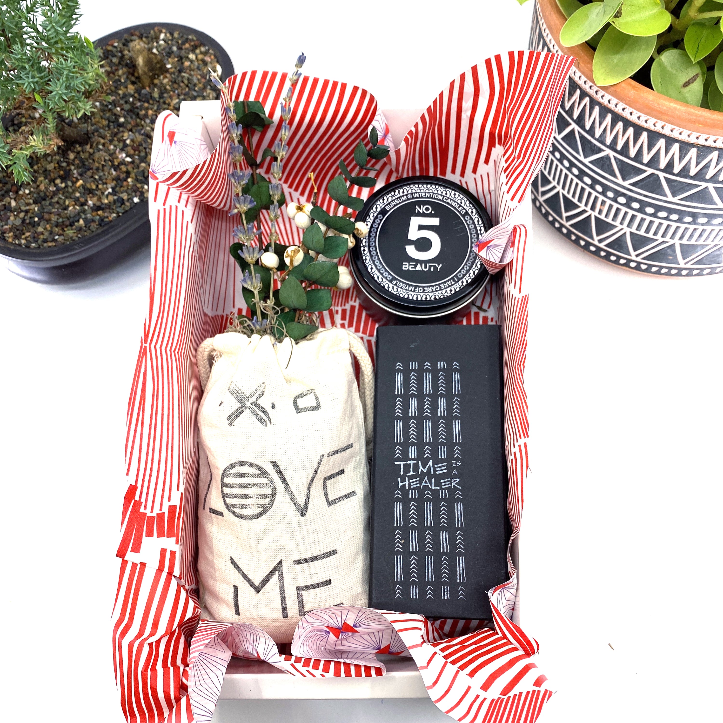 A beautifully arranged dried flower bouquet featuring lavender and eucalyptus, accompanied by a personal fragrance and intention candle, perfect for self-care.