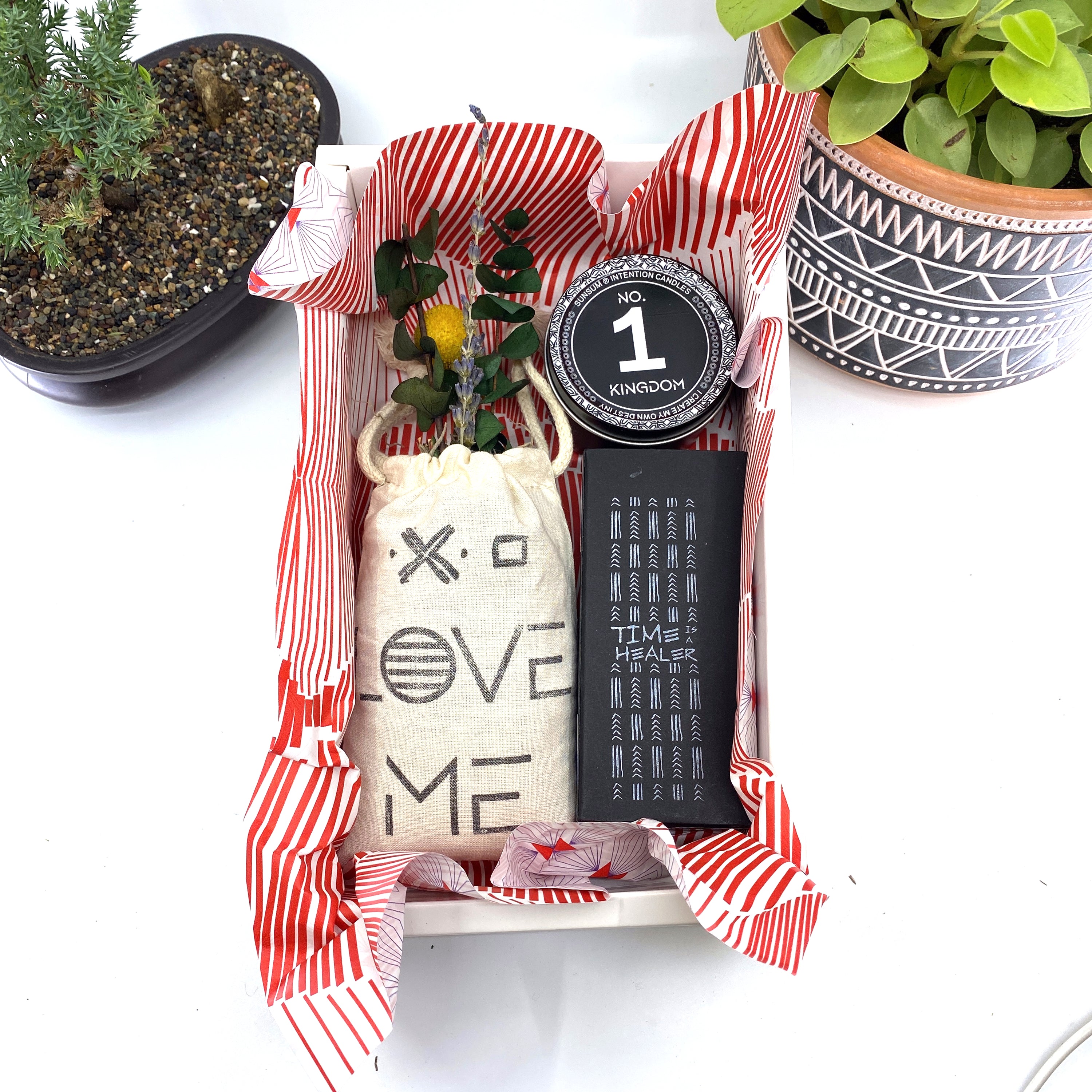 A beautifully arranged dried flower bouquet featuring lavender and eucalyptus, accompanied by a personal fragrance and intention candle, perfect for self-care.