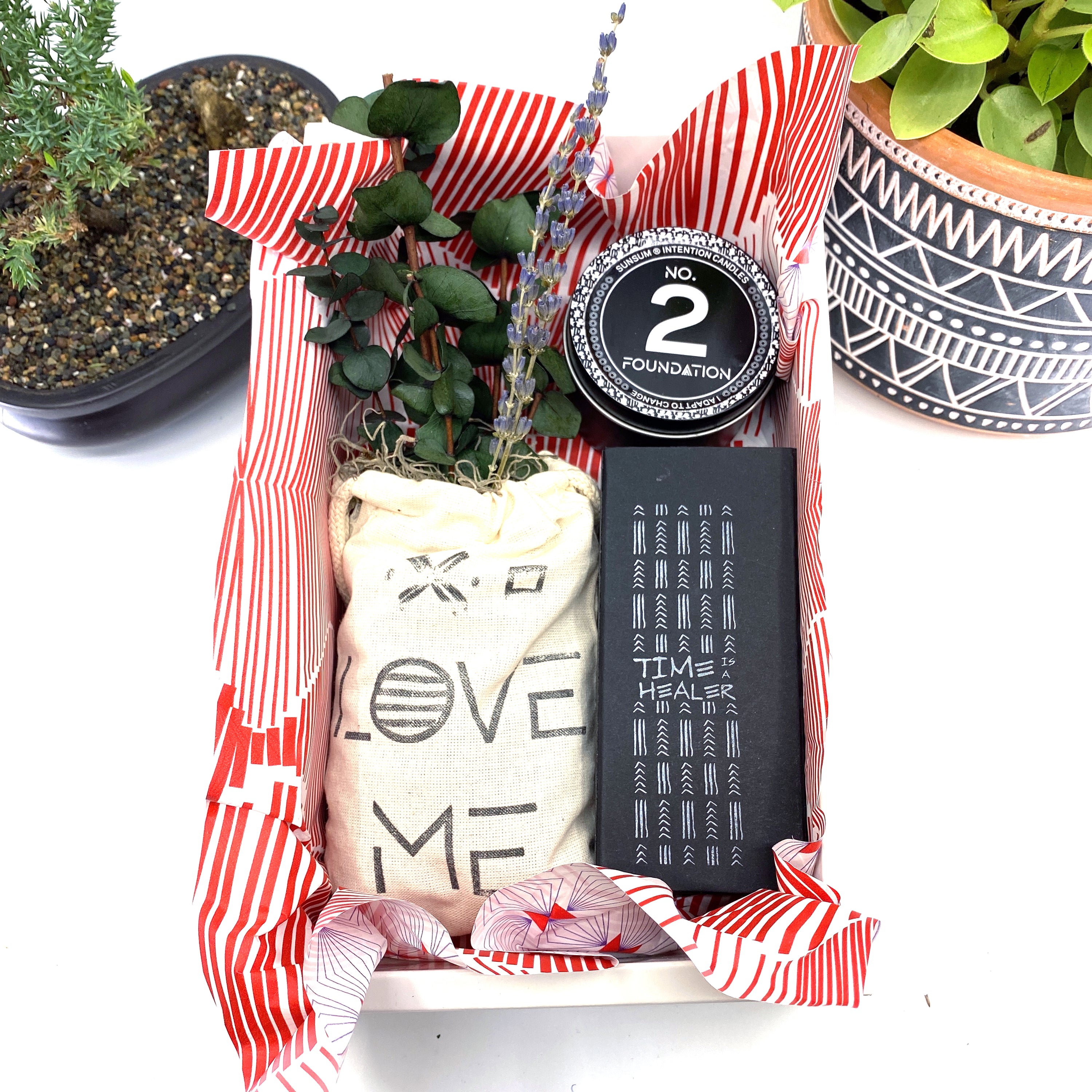 A beautifully arranged dried flower bouquet featuring lavender and eucalyptus, accompanied by a personal fragrance and intention candle, perfect for self-care.