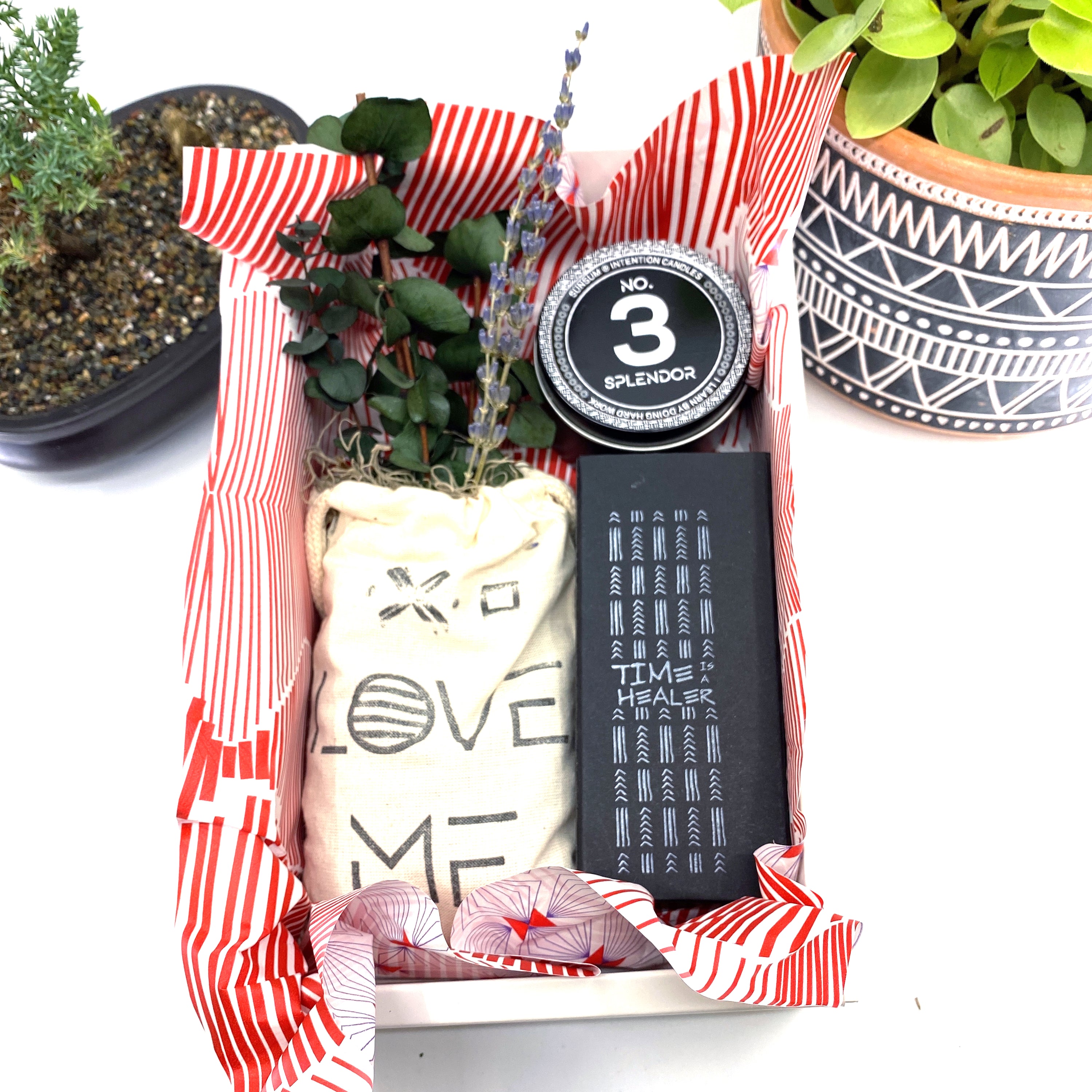 A beautifully arranged dried flower bouquet featuring lavender and eucalyptus, accompanied by a personal fragrance and intention candle, perfect for self-care.