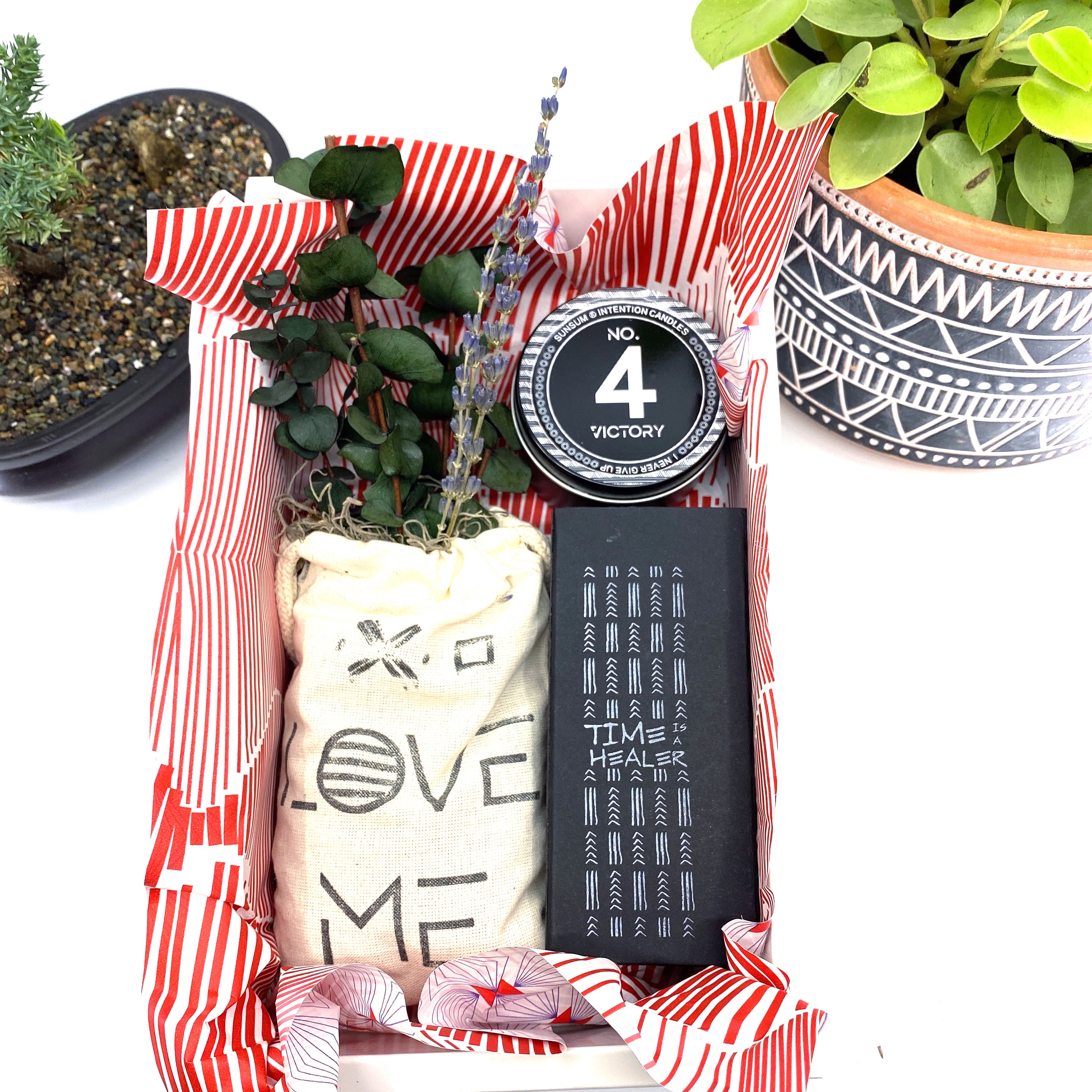 A beautifully arranged dried flower bouquet featuring lavender and eucalyptus, accompanied by a personal fragrance and intention candle, perfect for self-care.