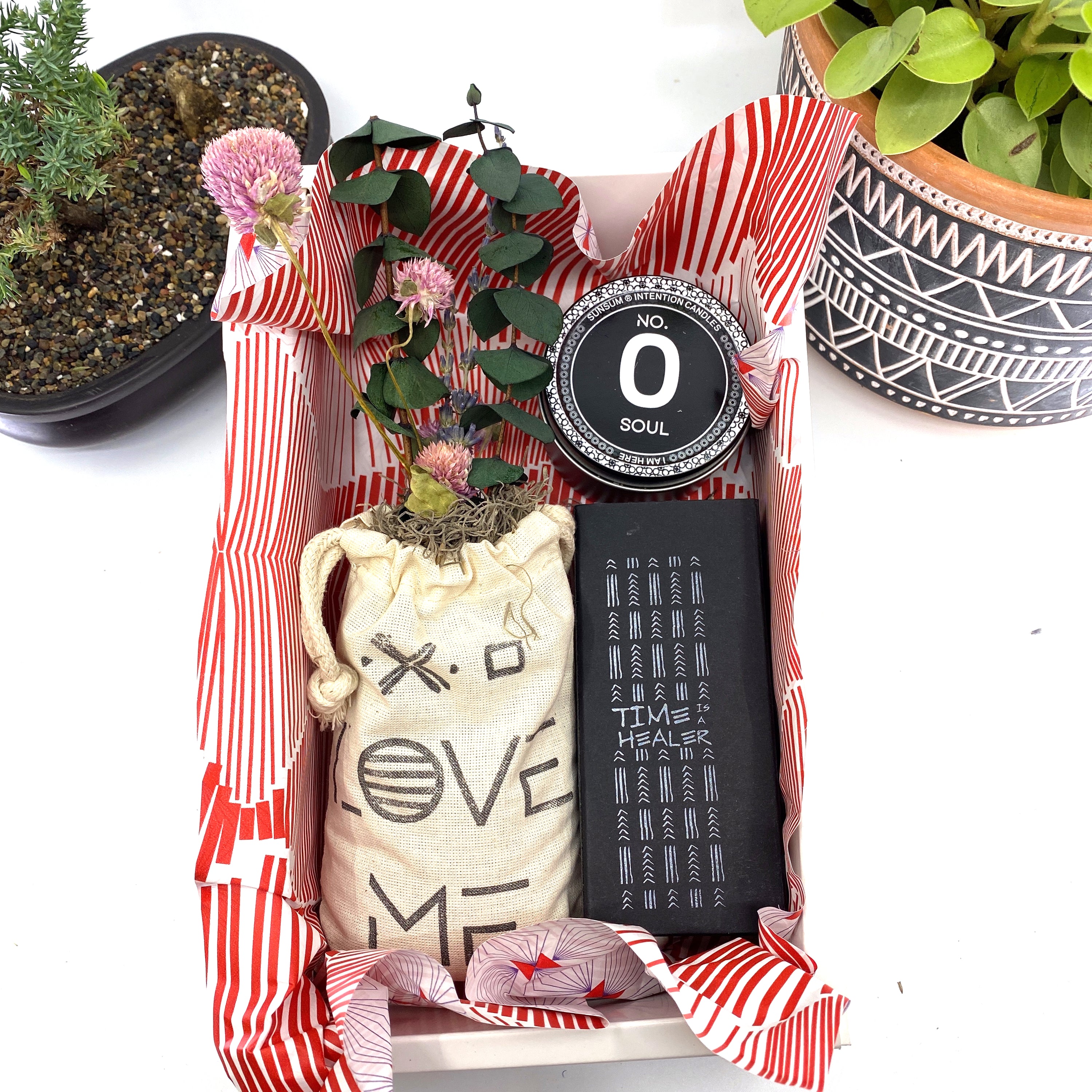 A beautifully arranged dried flower bouquet featuring lavender and eucalyptus, accompanied by a personal fragrance and intention candle, perfect for self-care.