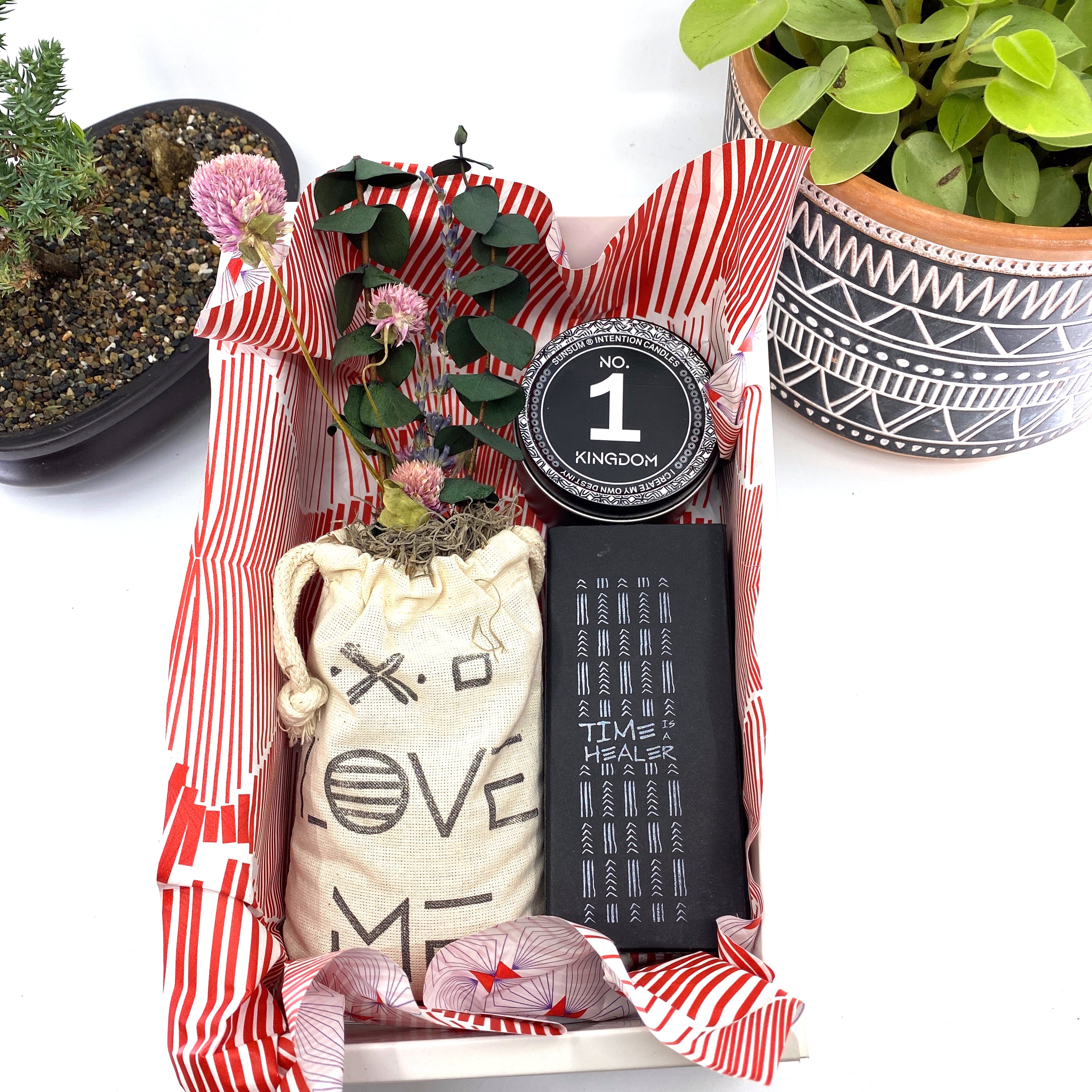 A beautifully arranged dried flower bouquet featuring lavender and eucalyptus, accompanied by a personal fragrance and intention candle, perfect for self-care.