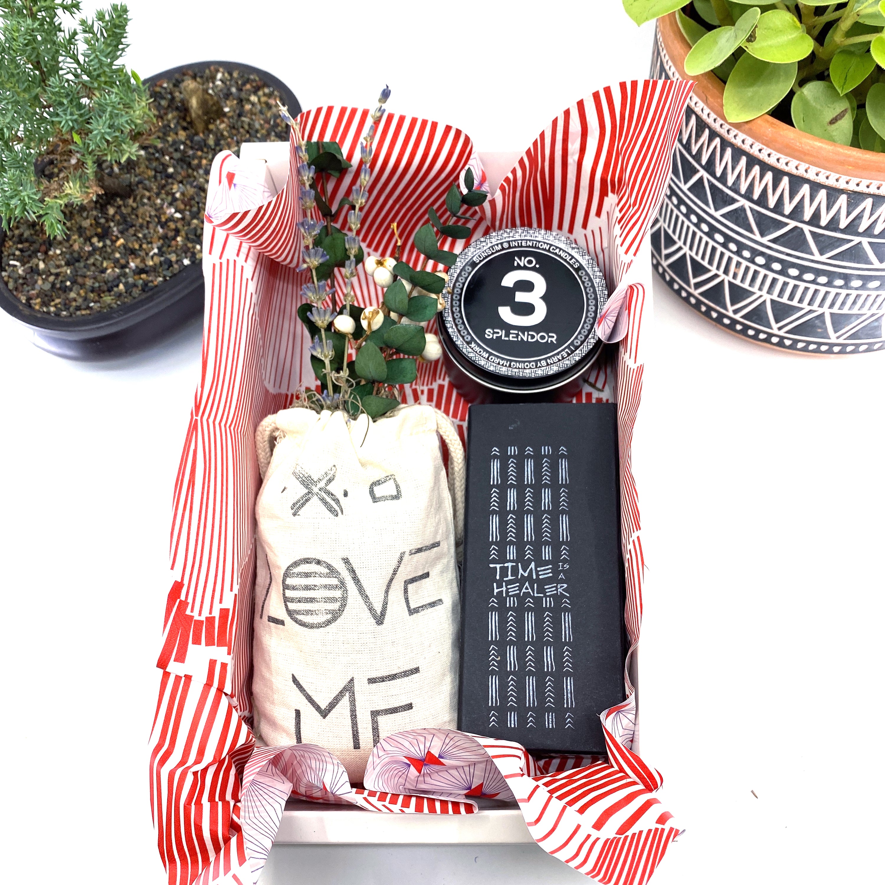 A beautifully arranged dried flower bouquet featuring lavender and eucalyptus, accompanied by a personal fragrance and intention candle, perfect for self-care.