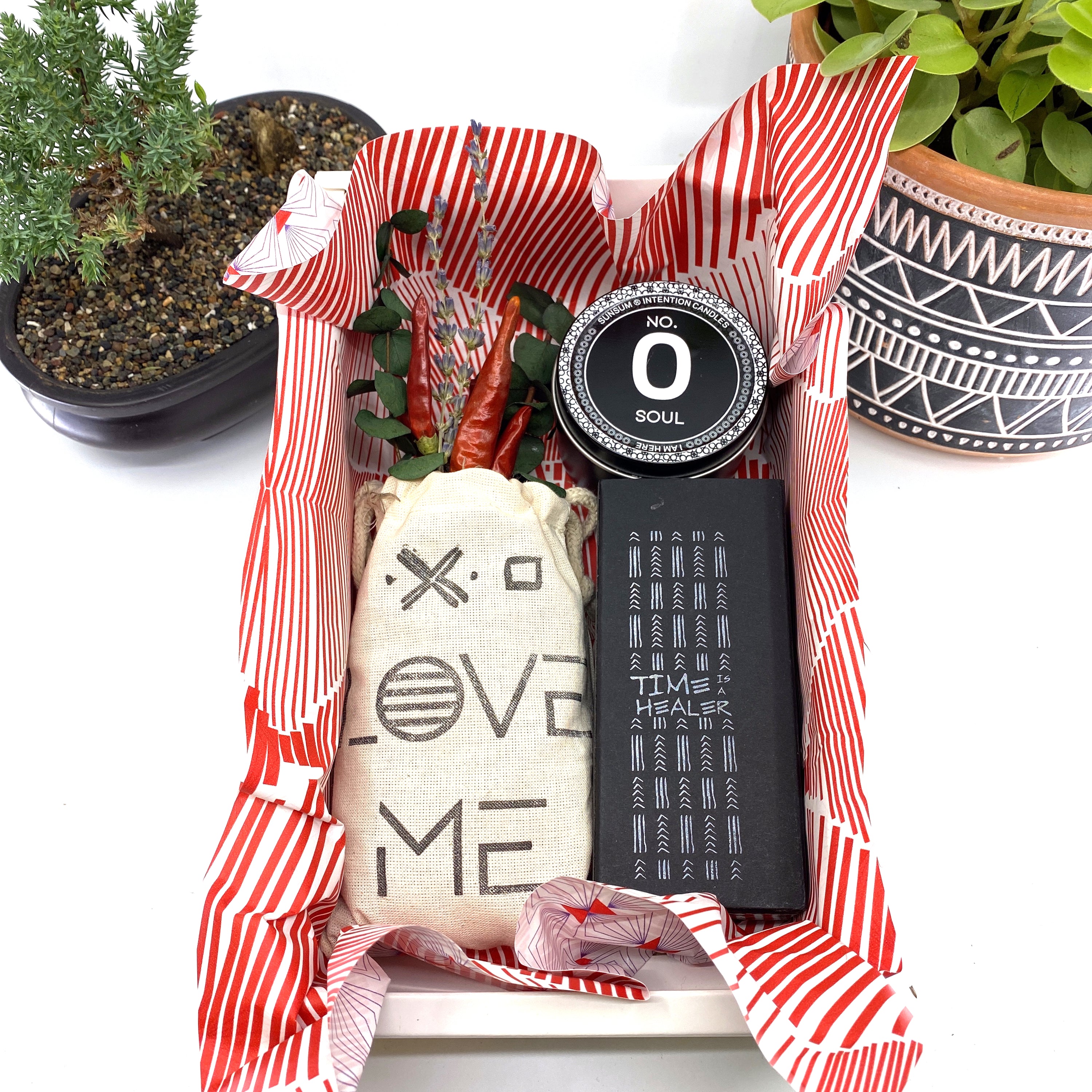 A beautifully arranged dried flower bouquet featuring lavender and eucalyptus, accompanied by a personal fragrance and intention candle, perfect for self-care.