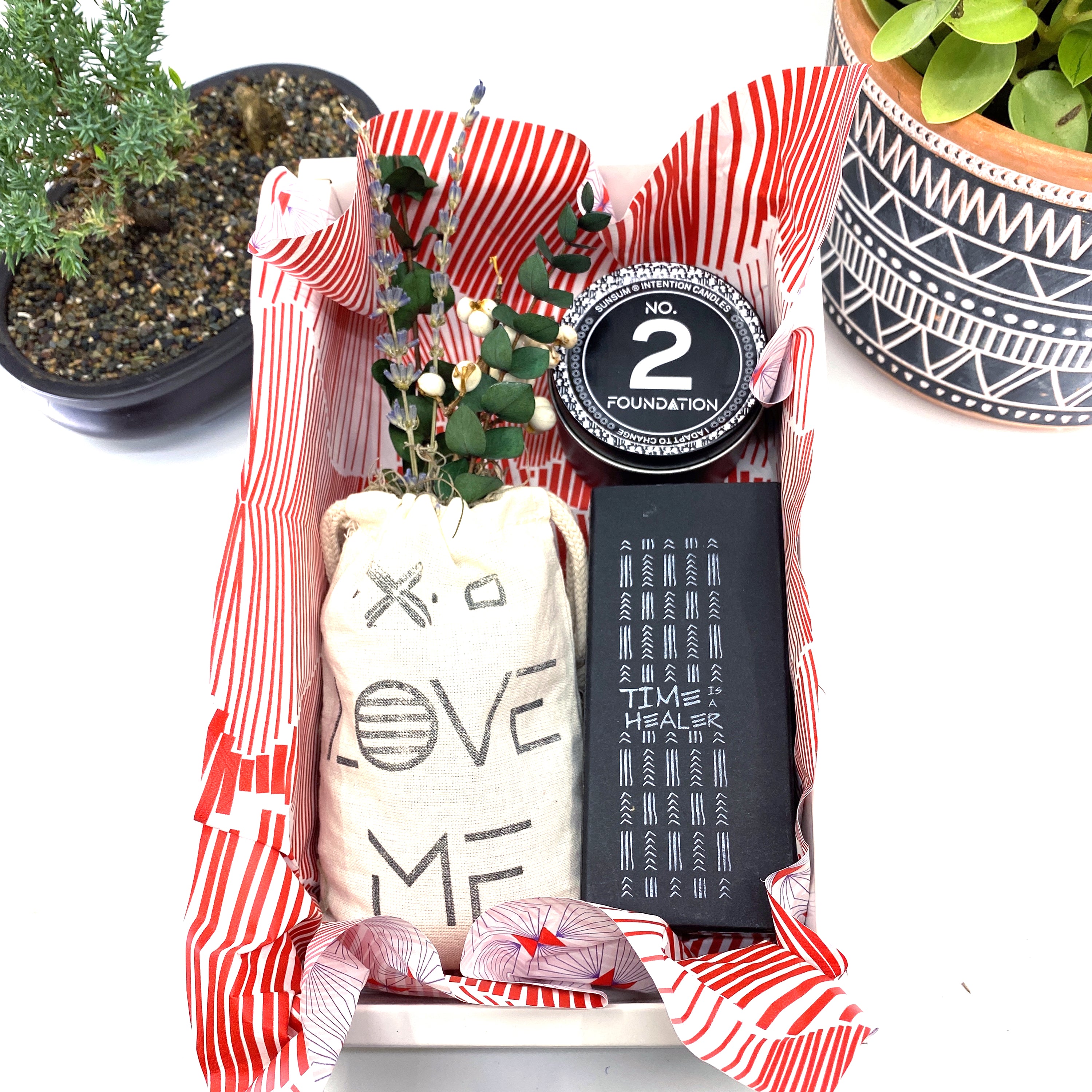 A beautifully arranged dried flower bouquet featuring lavender and eucalyptus, accompanied by a personal fragrance and intention candle, perfect for self-care.