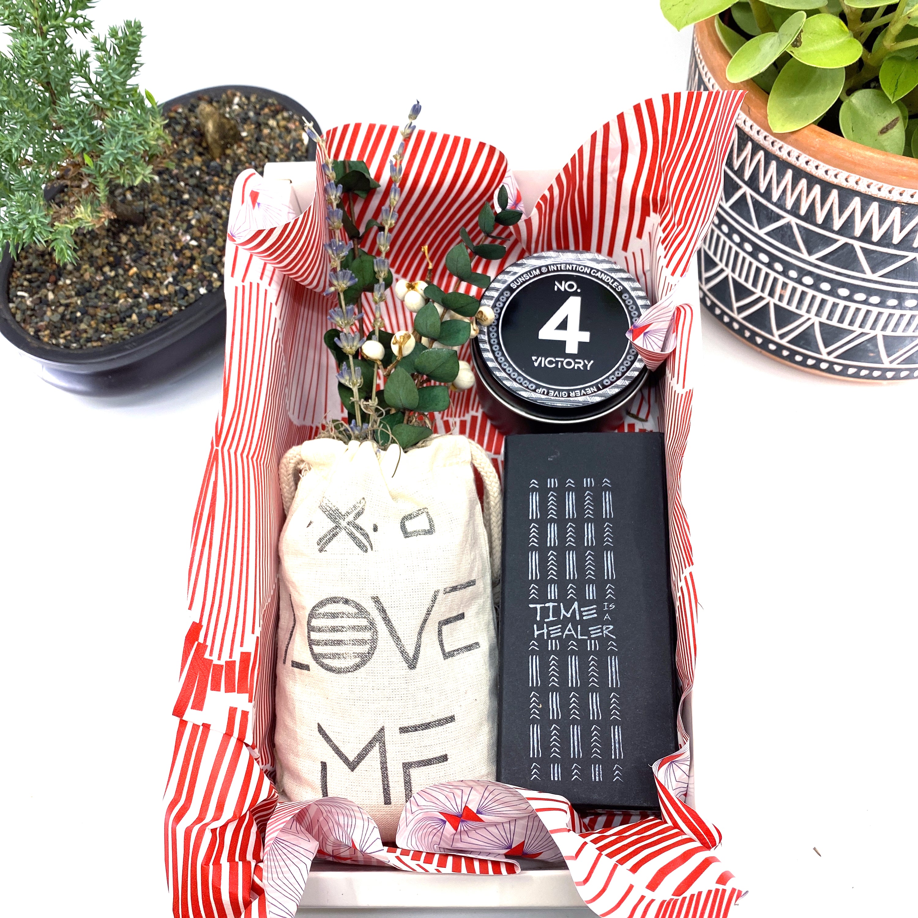 A beautifully arranged dried flower bouquet featuring lavender and eucalyptus, accompanied by a personal fragrance and intention candle, perfect for self-care.