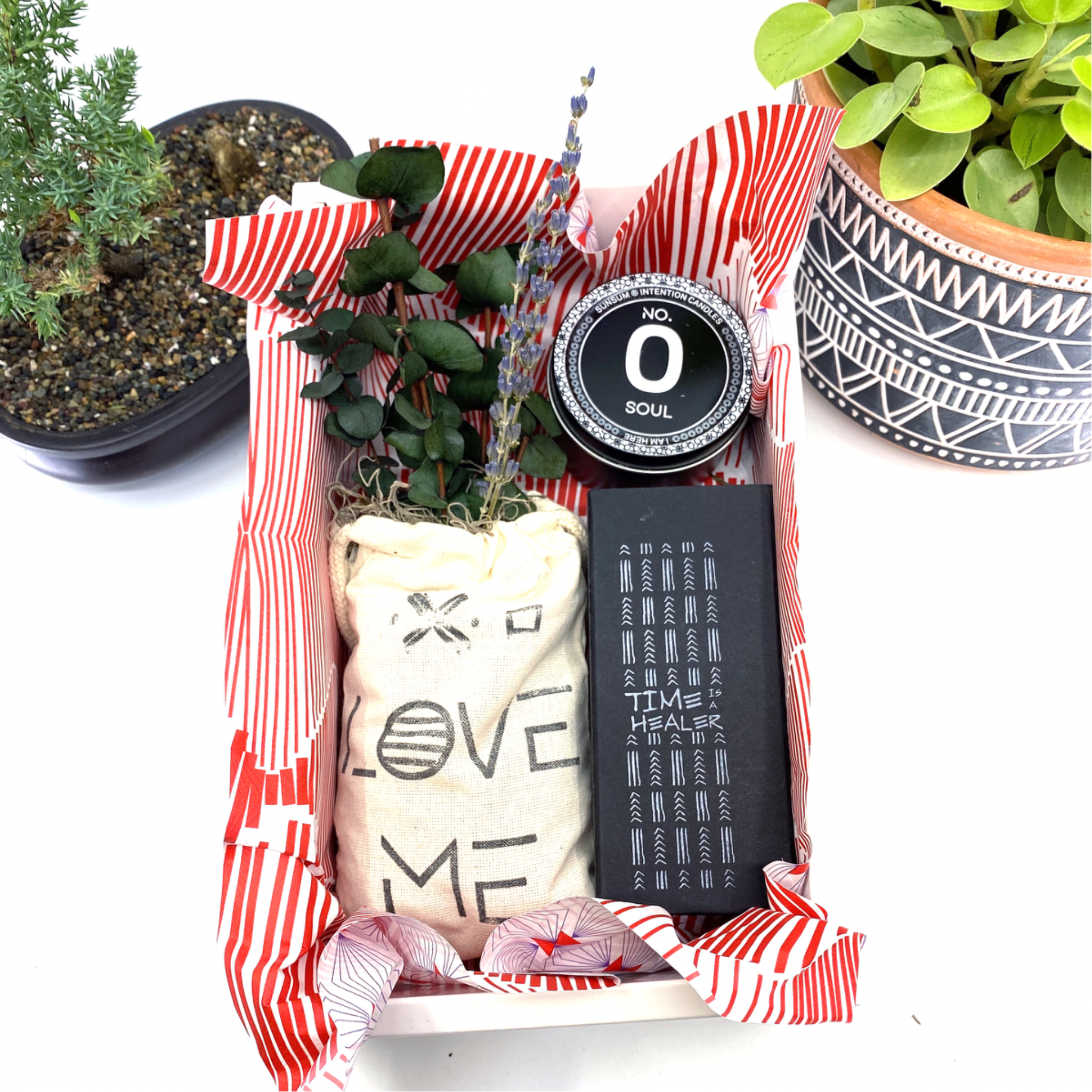 A beautifully arranged dried flower bouquet featuring lavender and eucalyptus, accompanied by a personal fragrance and intention candle, perfect for self-care.