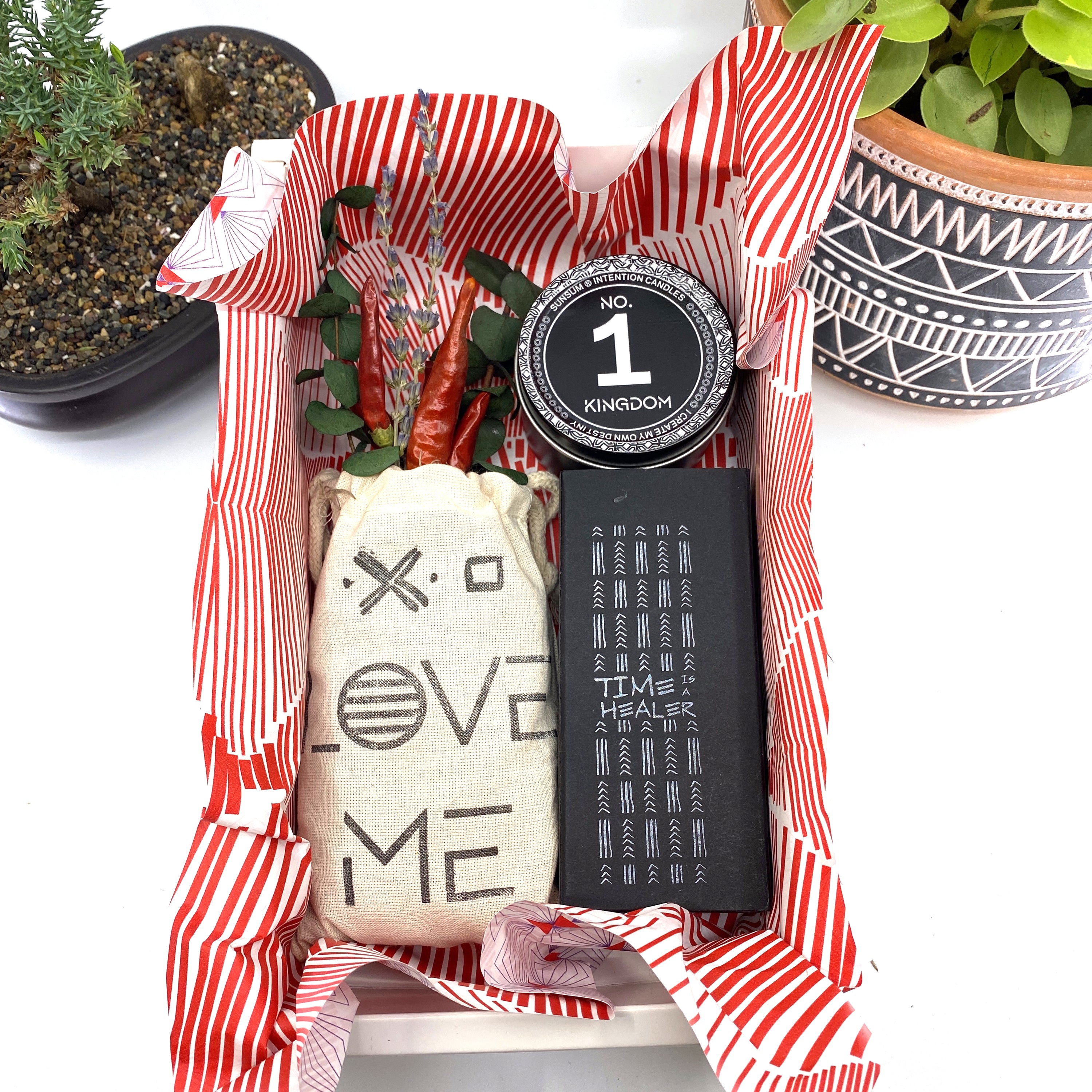 A beautifully arranged dried flower bouquet featuring lavender and eucalyptus, accompanied by a personal fragrance and intention candle, perfect for self-care.