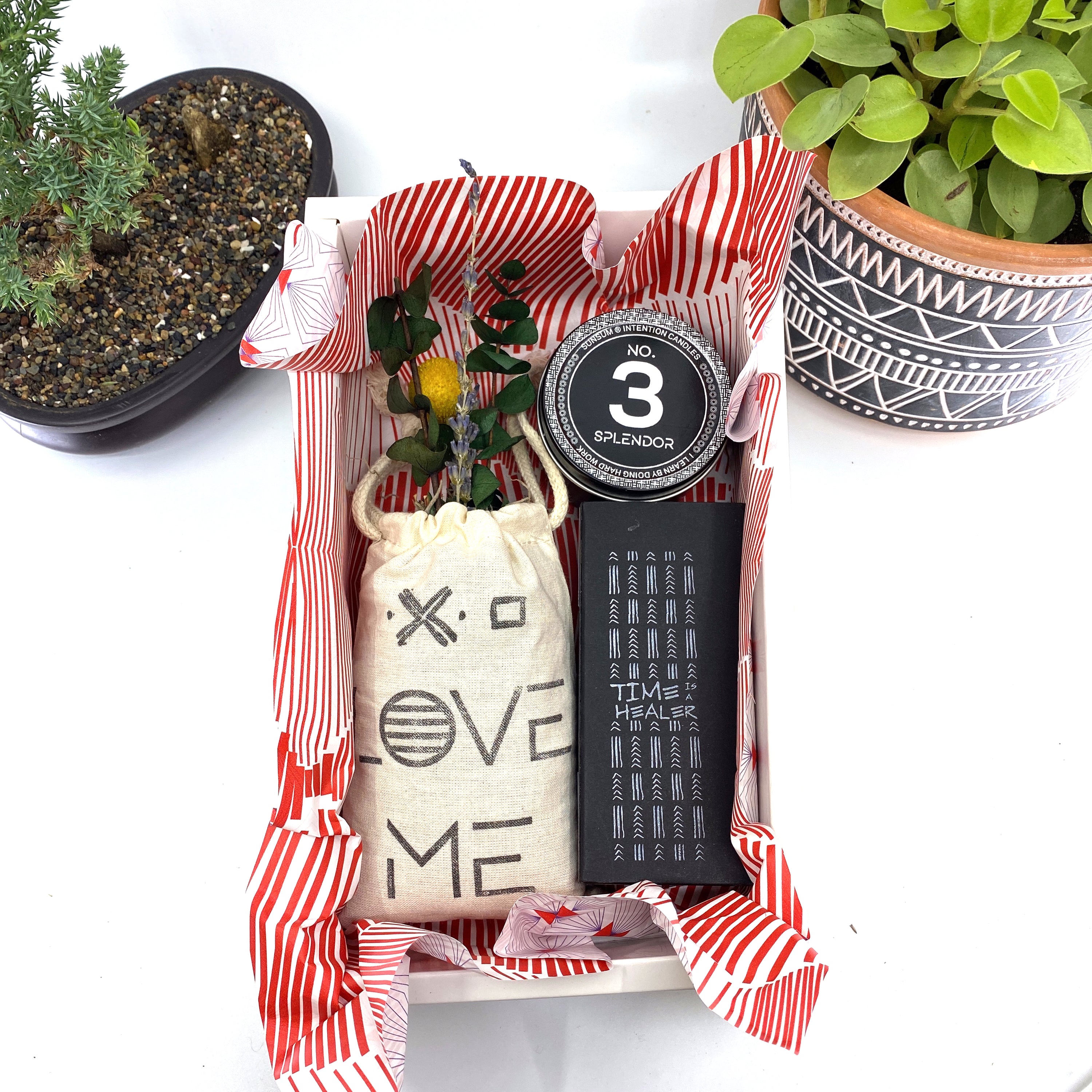 A beautifully arranged dried flower bouquet featuring lavender and eucalyptus, accompanied by a personal fragrance and intention candle, perfect for self-care.