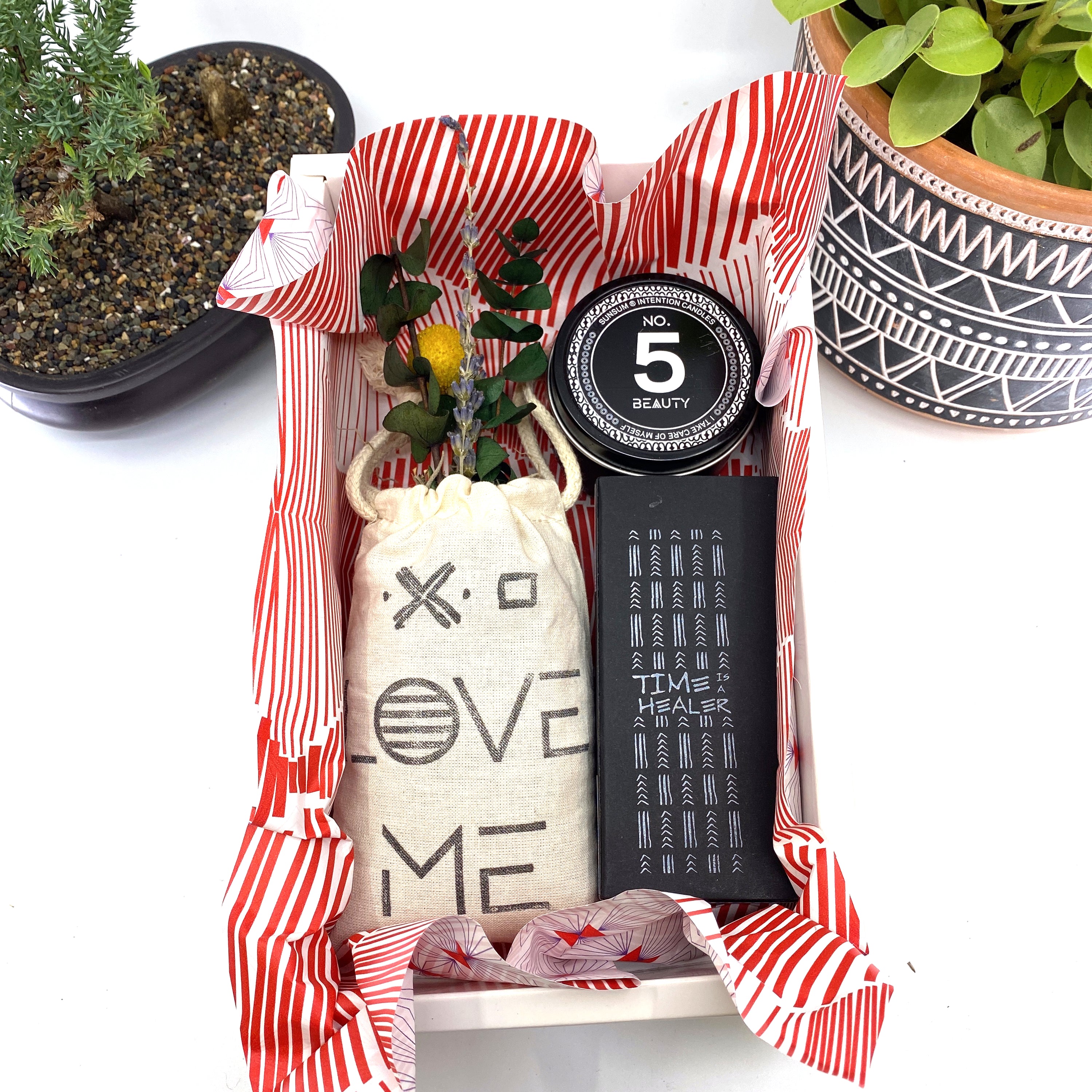 A beautifully arranged dried flower bouquet featuring lavender and eucalyptus, accompanied by a personal fragrance and intention candle, perfect for self-care.