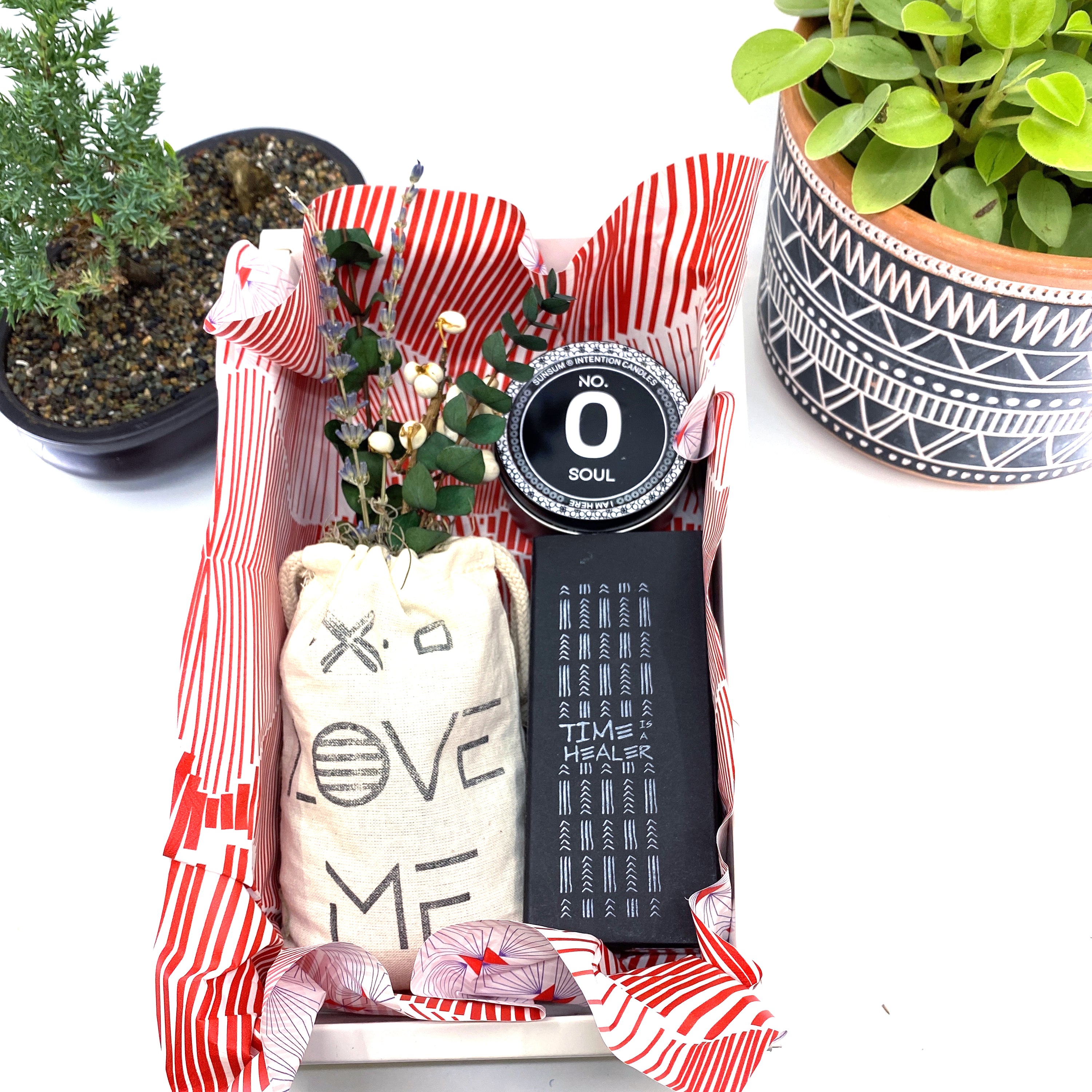 A beautifully arranged dried flower bouquet featuring lavender and eucalyptus, accompanied by a personal fragrance and intention candle, perfect for self-care.