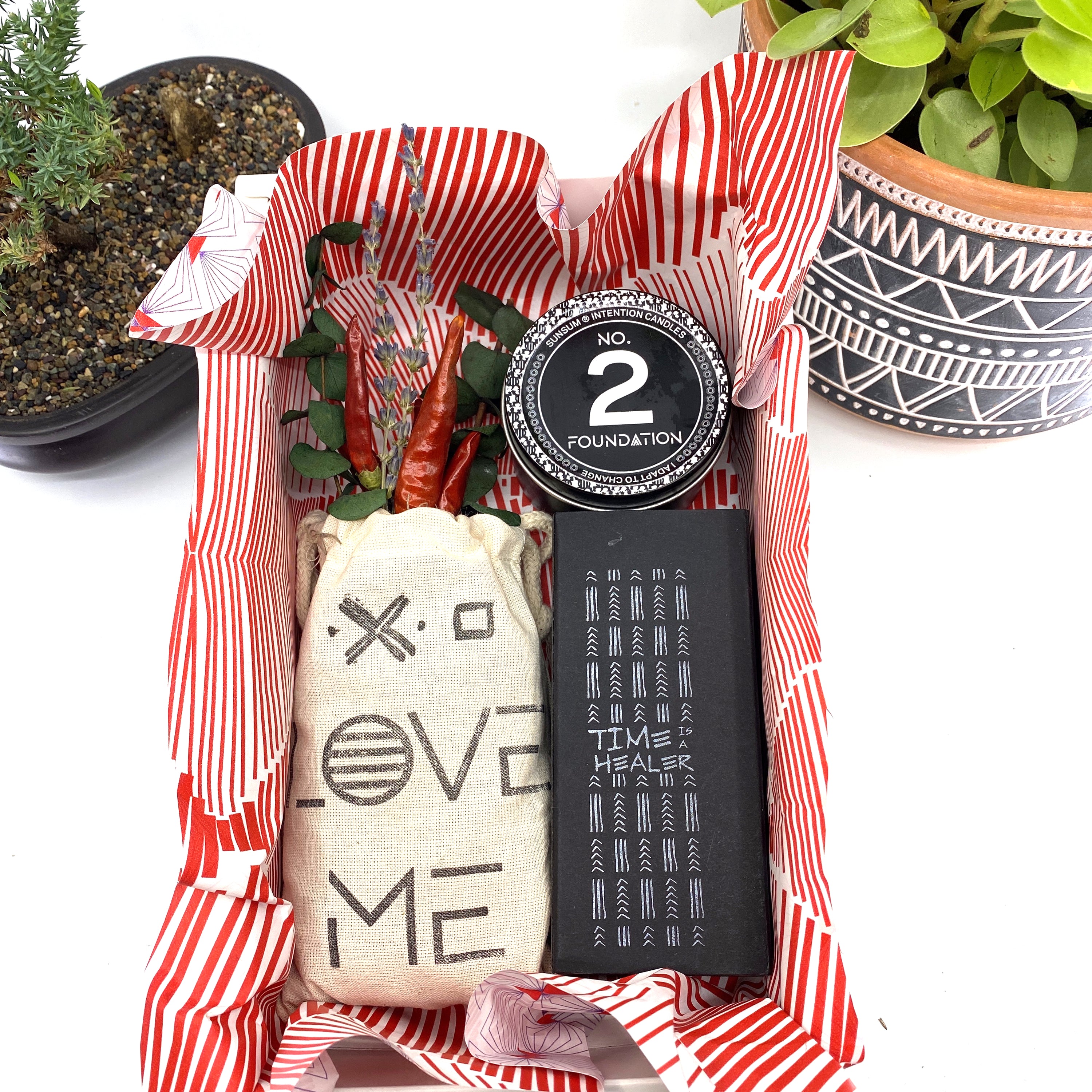 A beautifully arranged dried flower bouquet featuring lavender and eucalyptus, accompanied by a personal fragrance and intention candle, perfect for self-care.