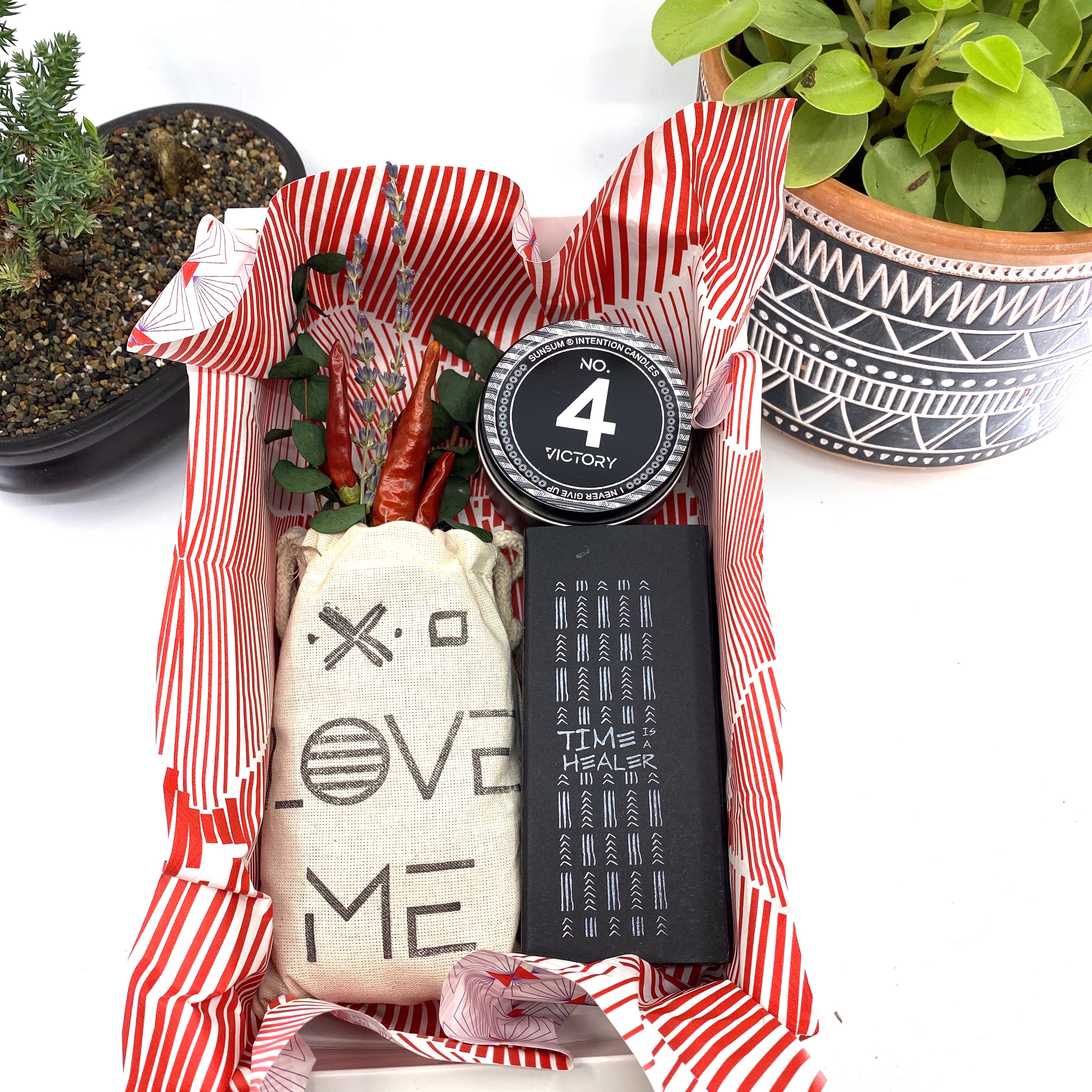 A beautifully arranged dried flower bouquet featuring lavender and eucalyptus, accompanied by a personal fragrance and intention candle, perfect for self-care.