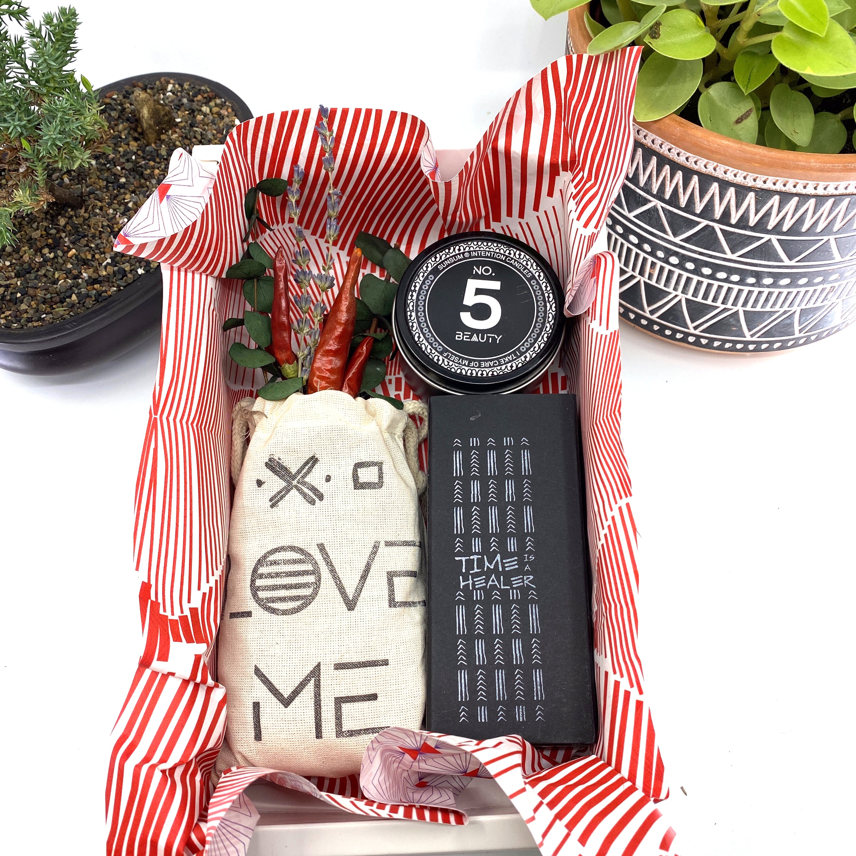 A beautifully arranged dried flower bouquet featuring lavender and eucalyptus, accompanied by a personal fragrance and intention candle, perfect for self-care.