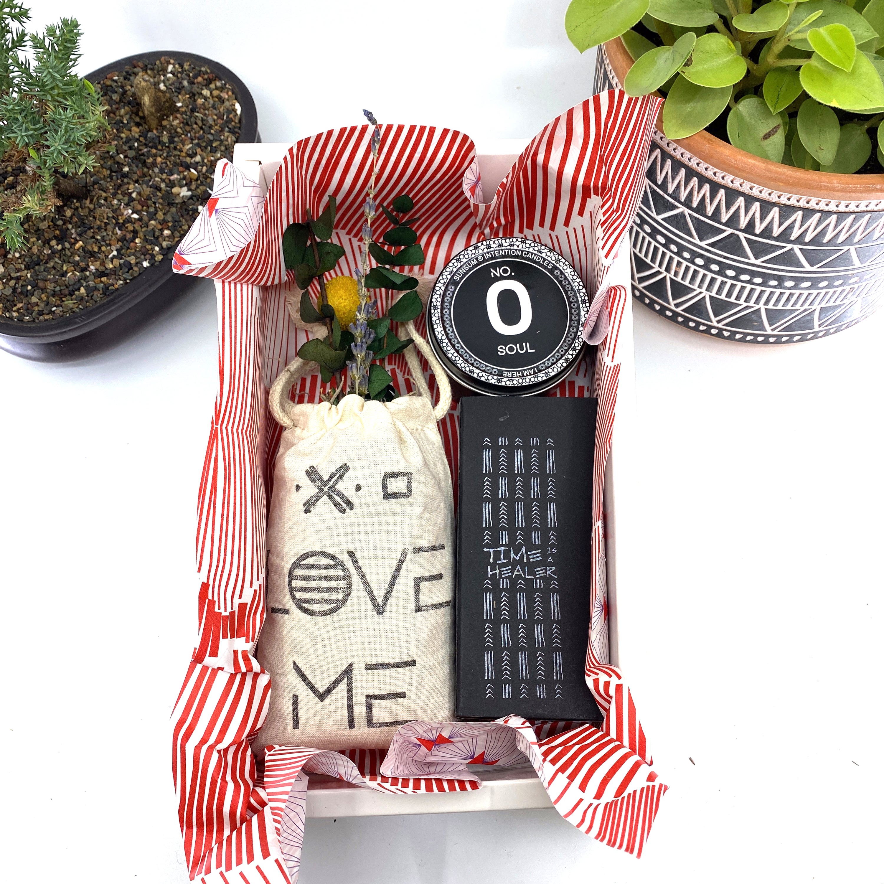 A beautifully arranged dried flower bouquet featuring lavender and eucalyptus, accompanied by a personal fragrance and intention candle, perfect for self-care.