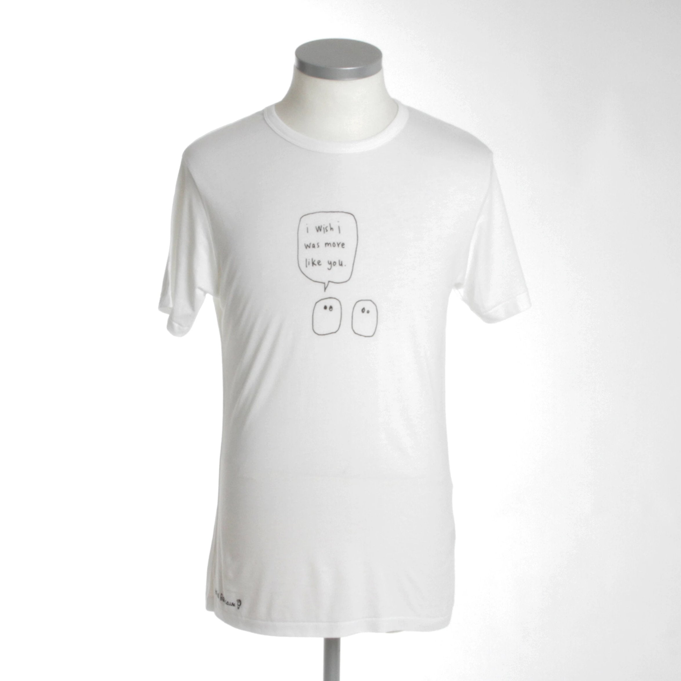 More Like You Blobs Bamboo Tee Shirt in black ink on white fabric, featuring a hand-printed logo at the hip.