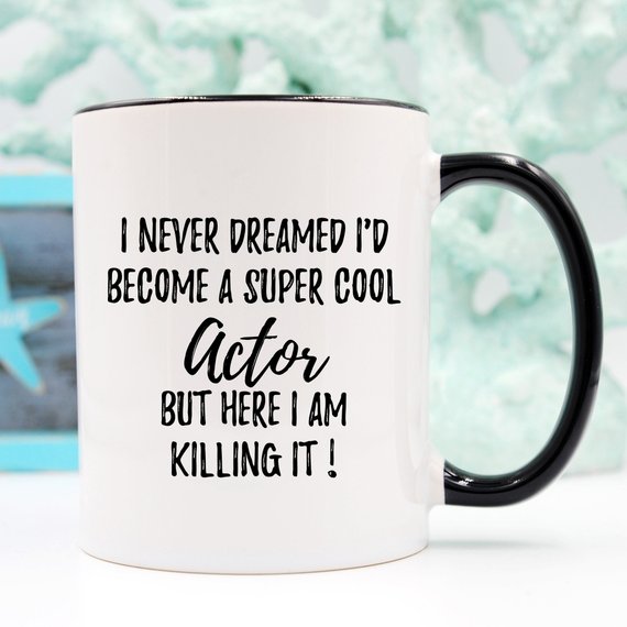 A stylish white ceramic mug featuring a vibrant design related to acting, perfect for gifts.