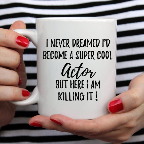 A stylish white ceramic mug featuring a vibrant design related to acting, perfect for gifts.