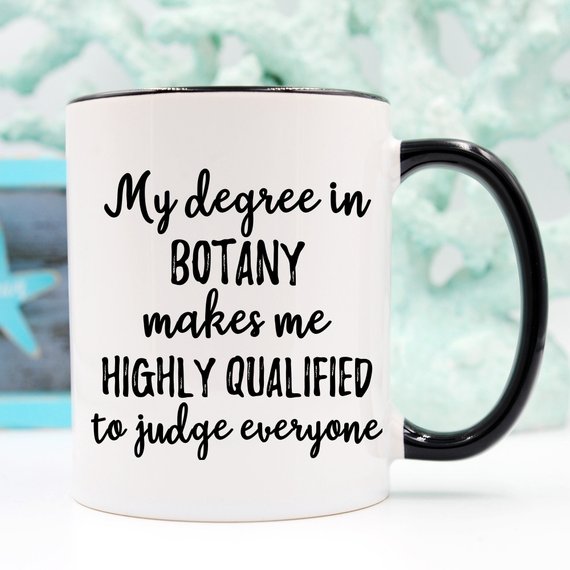 A stylish white botany mug featuring vibrant plant designs on both sides, perfect for coffee or tea.