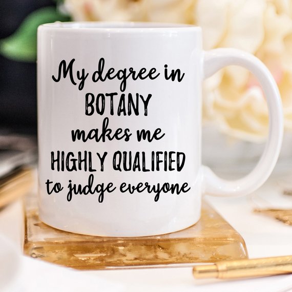 A stylish white botany mug featuring vibrant plant designs on both sides, perfect for coffee or tea.