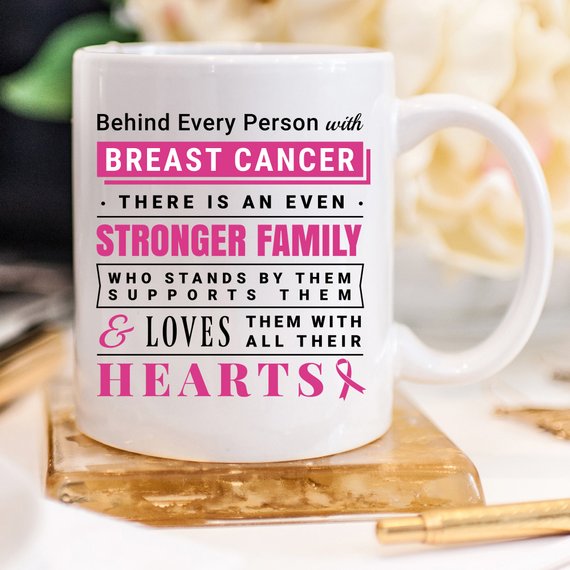 Ceramic coffee mug with a heartfelt message about breast cancer support, featuring vibrant colors and a unique design.