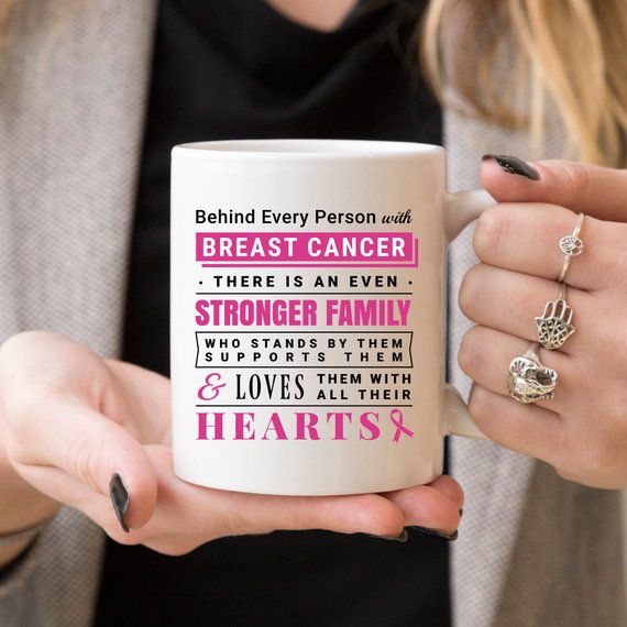 Ceramic coffee mug with a heartfelt message about breast cancer support, featuring vibrant colors and a unique design.