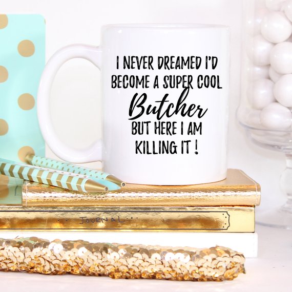 A white ceramic mug featuring a vibrant butcher-themed design printed on both sides, showcasing its high-quality craftsmanship and durability.