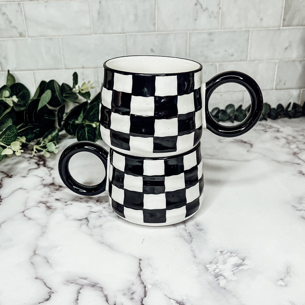 A stylish BW Checkered Mug featuring a hand-painted black and white checkered design, perfect for coffee, tea, or hot chocolate.