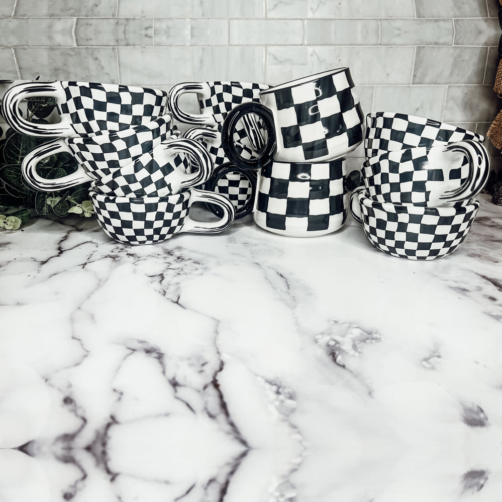 A stylish BW Checkered Mug featuring a hand-painted black and white checkered design, perfect for coffee, tea, or hot chocolate.