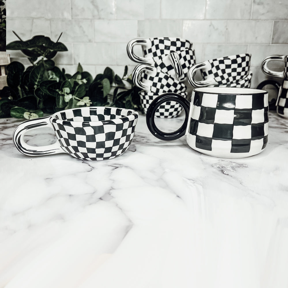 A stylish BW Checkered Mug featuring a hand-painted black and white checkered design, perfect for coffee, tea, or hot chocolate.