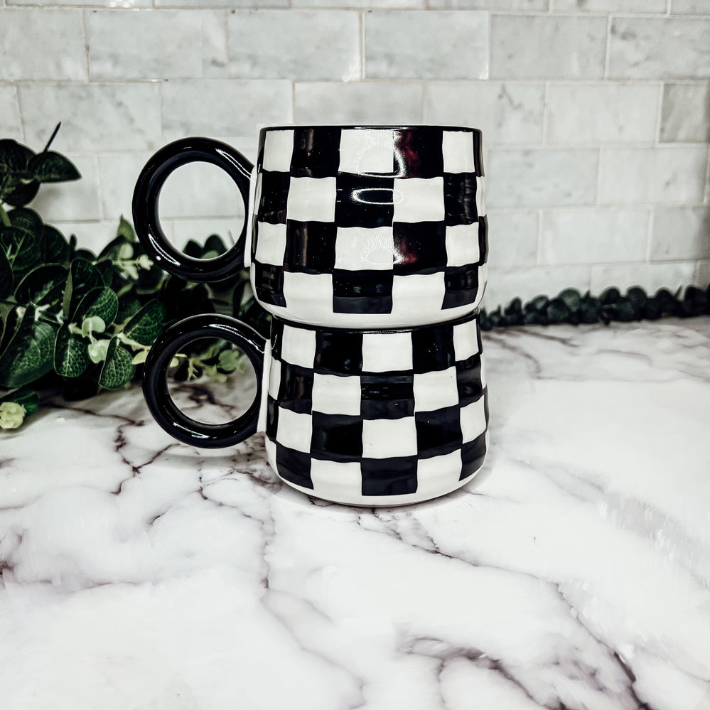 A stylish BW Checkered Mug featuring a hand-painted black and white checkered design, perfect for coffee, tea, or hot chocolate.