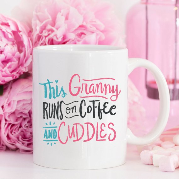 A humorous coffee mug featuring the phrase 'This Granny Runs On Coffee And Cuddles', crafted from high-grade ceramic.
