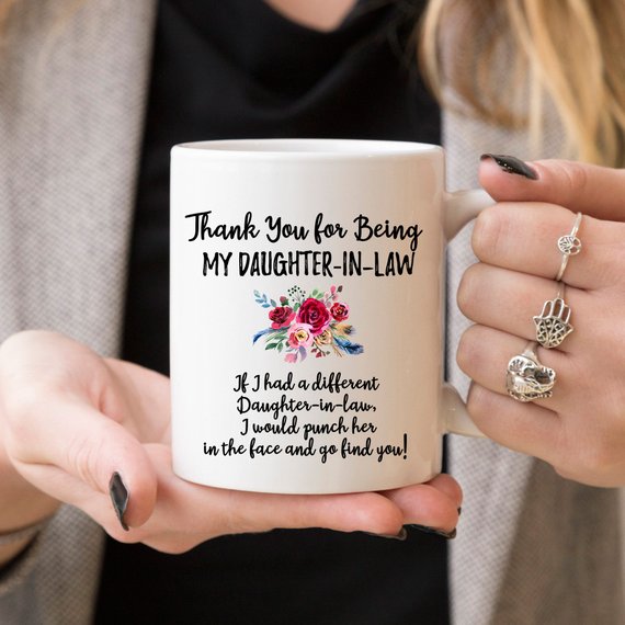 A beautiful white ceramic mug designed for daughters-in-law, featuring a vibrant printed design on both sides, showcasing quality craftsmanship.