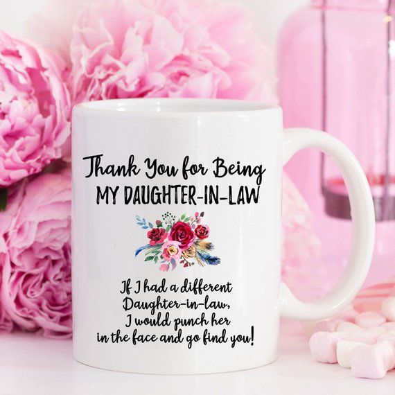 A beautiful white ceramic mug designed for daughters-in-law, featuring a vibrant printed design on both sides, showcasing quality craftsmanship.