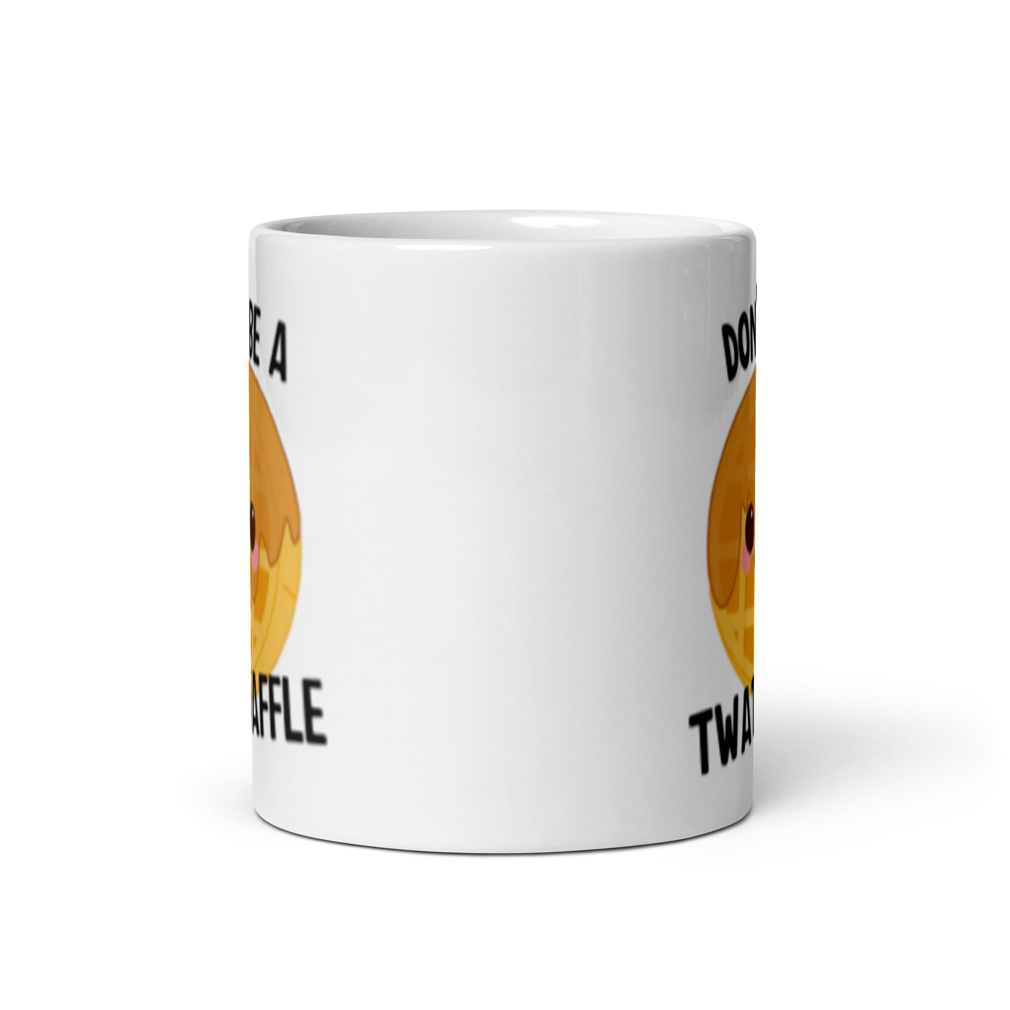 A ceramic mug with the phrase 'Don't Be A Twat Waffle' printed on both sides, showcasing a fun and quirky design.