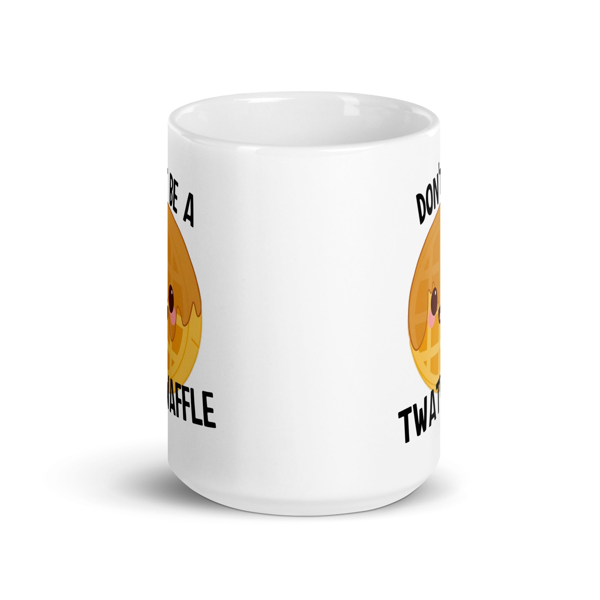 A ceramic mug with the phrase 'Don't Be A Twat Waffle' printed on both sides, showcasing a fun and quirky design.