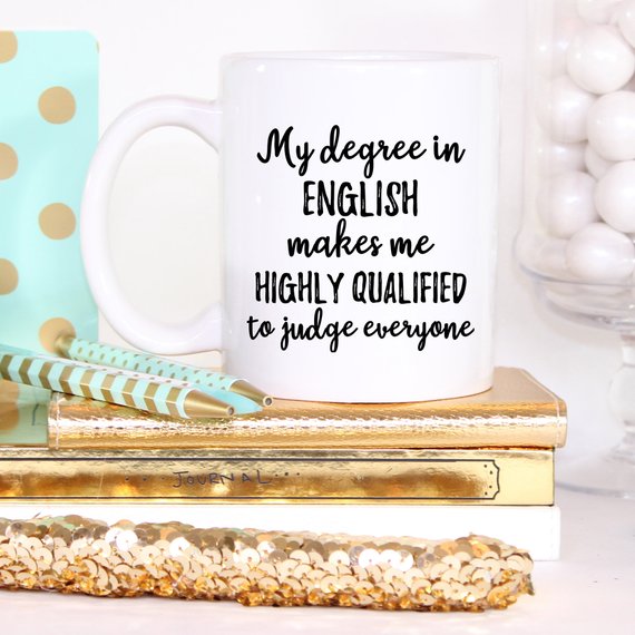 A stylish white ceramic mug designed for English teachers, featuring a vibrant design printed on both sides.