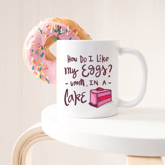 A white ceramic coffee mug with a funny design, suitable for women, showcasing vibrant colors and printed on both sides.