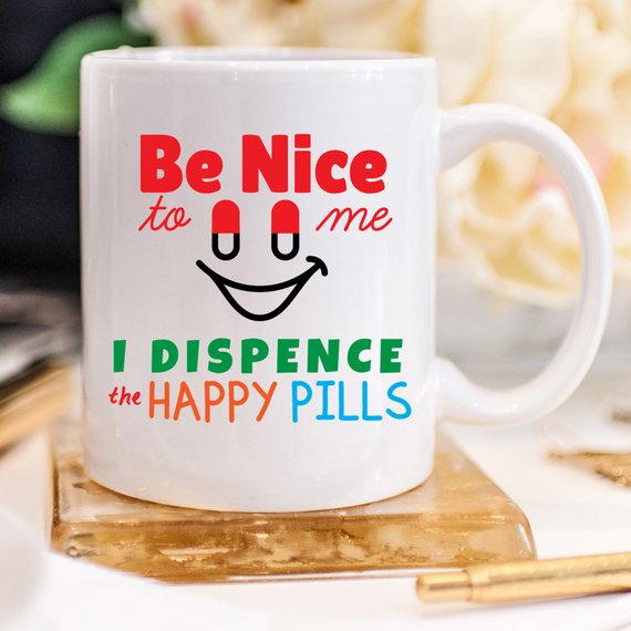 Funny Nurse Mug featuring the phrase 'Be Nice To Me, I Dispence The Happy Pills', designed for nurses with a humorous touch.