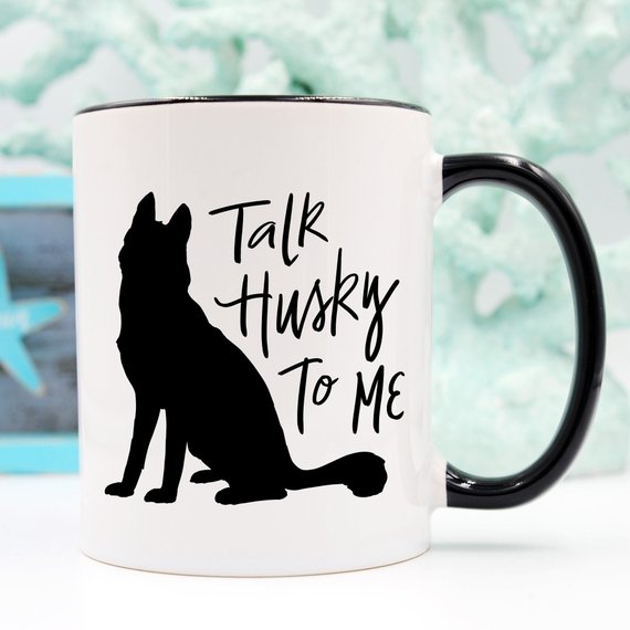 A humorous coffee mug featuring the phrase 'Talk Husky To Me', designed for dog lovers, made from high-quality ceramic.