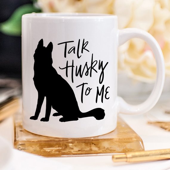 A humorous coffee mug featuring the phrase 'Talk Husky To Me', designed for dog lovers, made from high-quality ceramic.