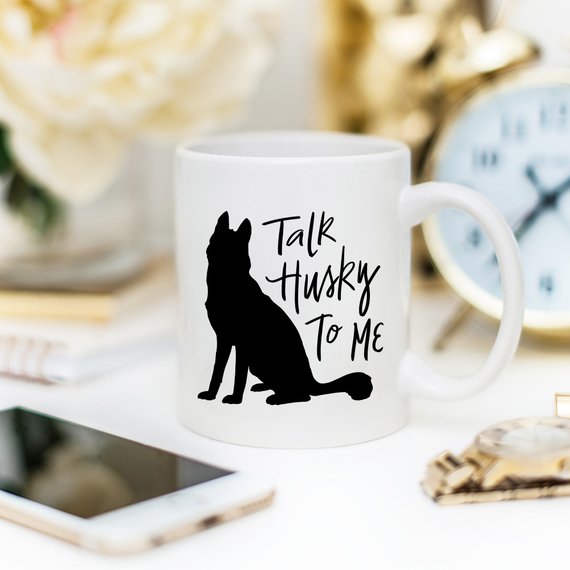 A humorous coffee mug featuring the phrase 'Talk Husky To Me', designed for dog lovers, made from high-quality ceramic.