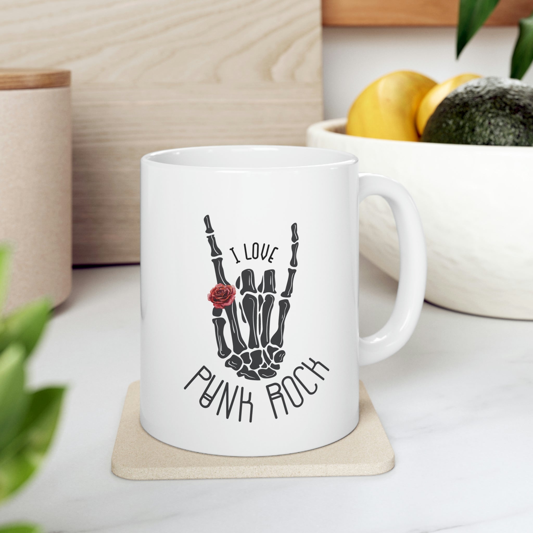 I Love Punk Rock Skeleton Hand Mug featuring a unique skeleton hand design on a white ceramic surface.