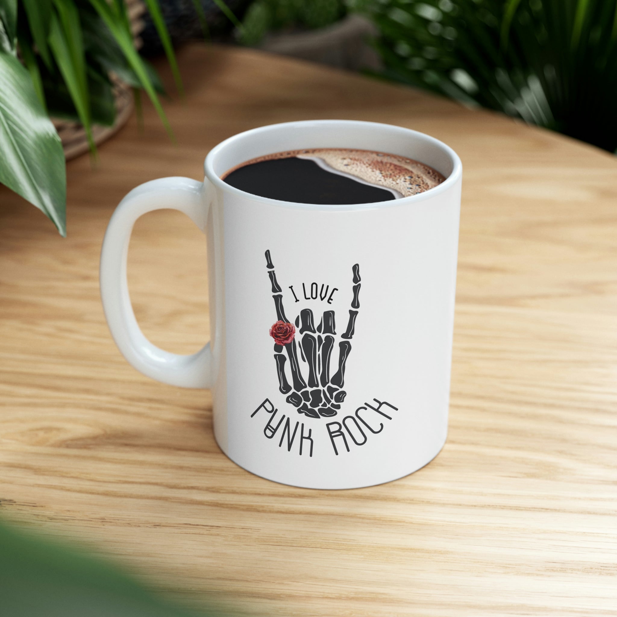I Love Punk Rock Skeleton Hand Mug featuring a unique skeleton hand design on a white ceramic surface.